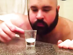 bear drinking its own milk in the cup